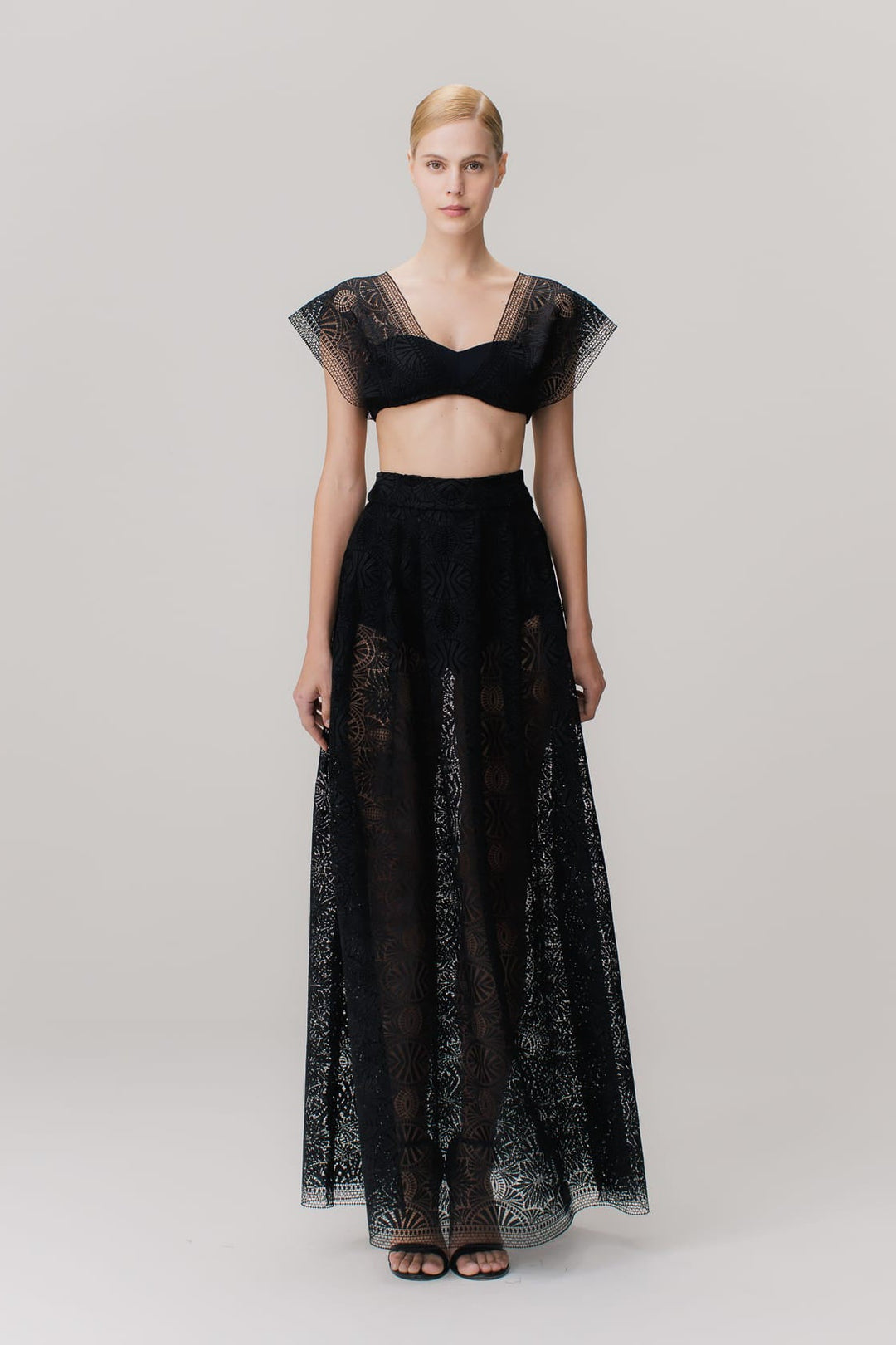 A long black skirt with embroidery and a side closure with a black metal zipper.