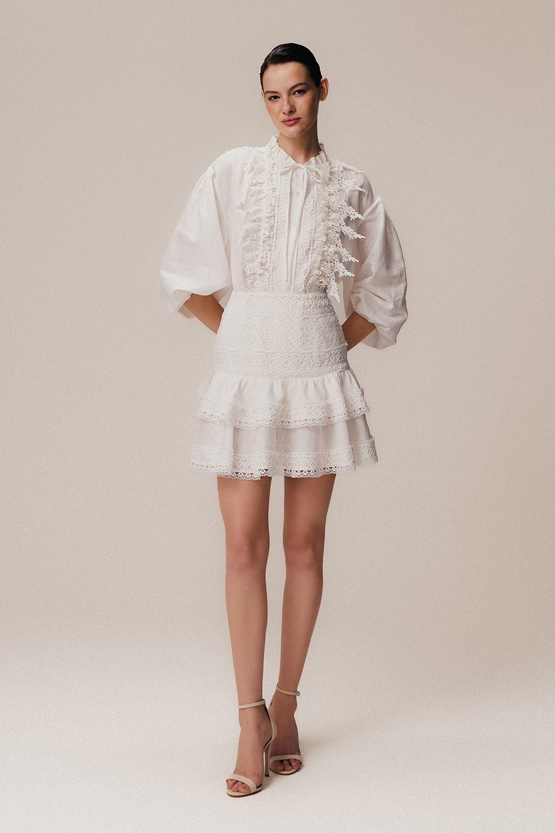 An off-white, long sleeve linen shirt with Guipir lace detailing, a crew collar, and front button closure.