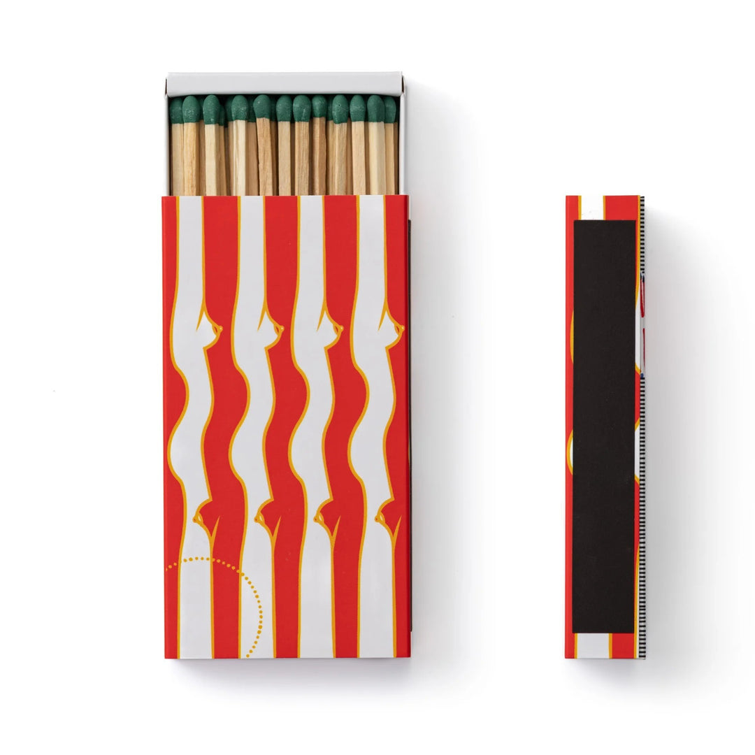 A slim matte edition matchbox with an exclusive illustration by Gisela Pecego