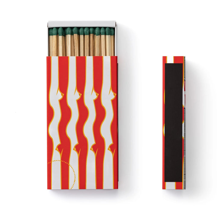 A slim matte edition matchbox with an exclusive illustration by Gisela Pecego