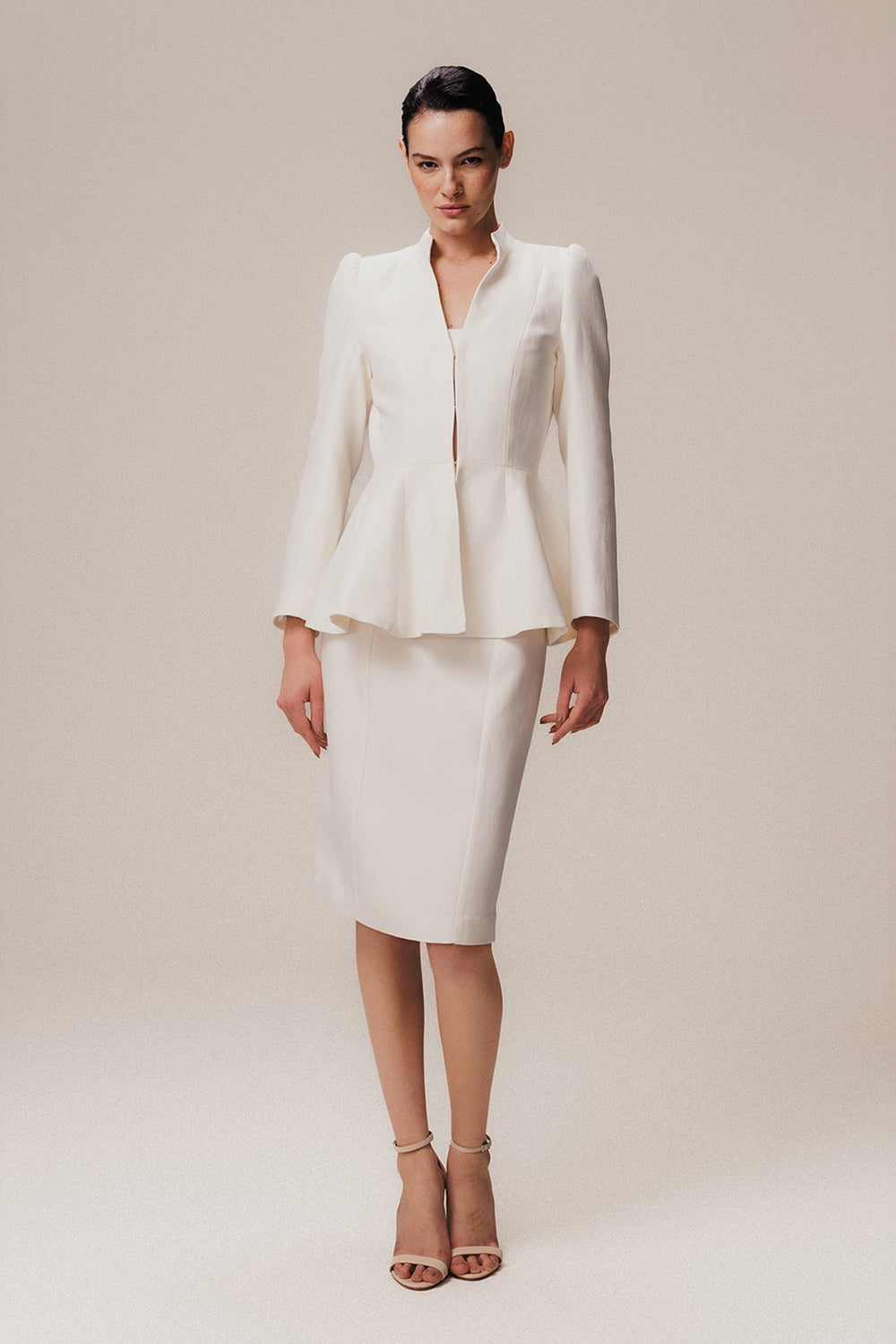 a knee-length off-white skirt with a tailored fit and high waist design
